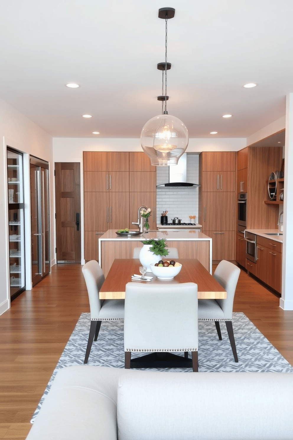 A stylish kitchen dining room combo featuring a spacious pantry for additional storage. The kitchen showcases sleek cabinetry in a warm wood finish, complemented by a large island with bar seating. Adjacent to the kitchen, a cozy dining area is adorned with a modern table and upholstered chairs. Soft pendant lighting hangs above the table, creating an inviting atmosphere for family meals.