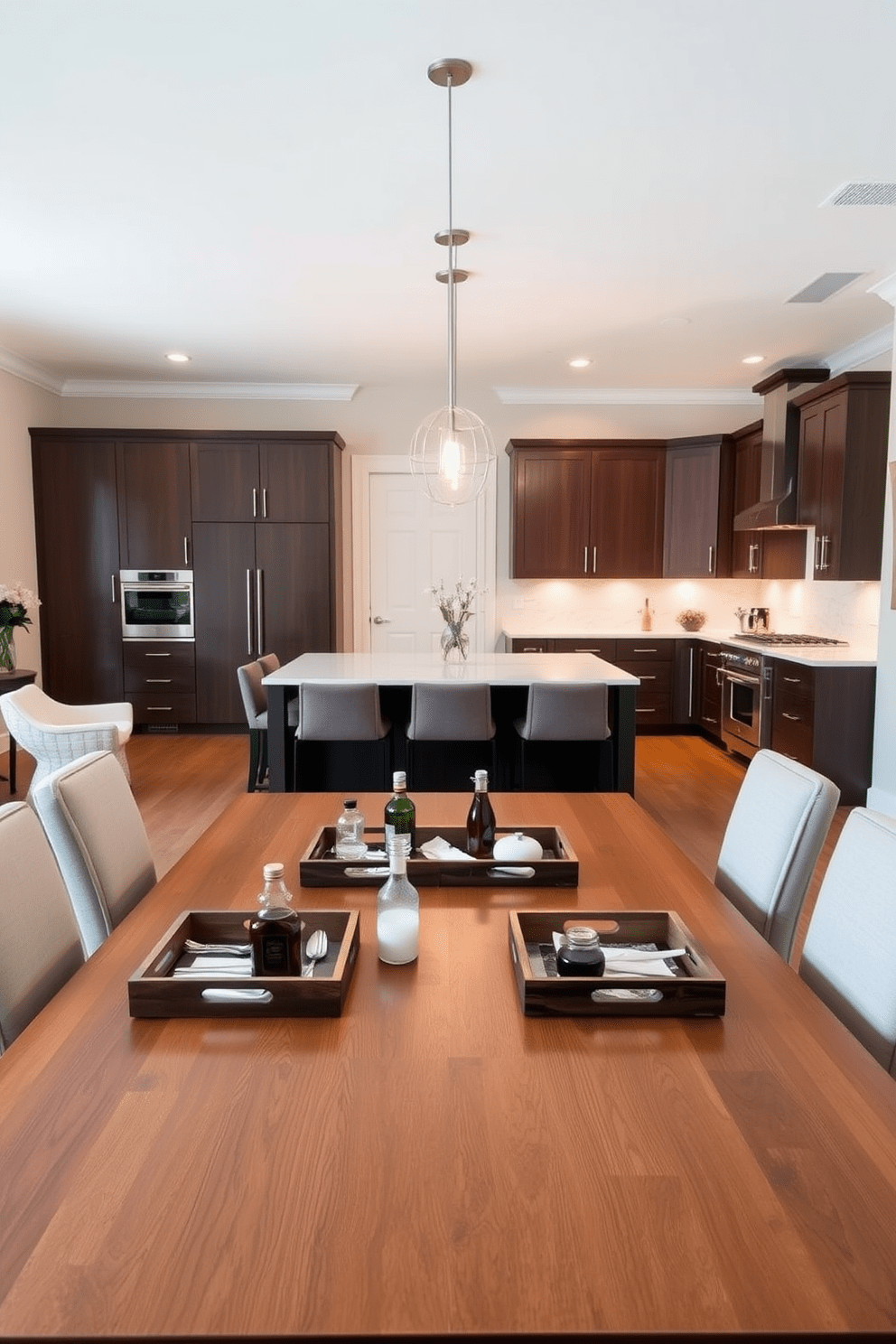 A stylish kitchen dining room combo featuring a large wooden dining table surrounded by upholstered chairs. On the table, decorative trays are used to organize condiments and utensils, adding a touch of elegance to the space. The kitchen area boasts sleek cabinetry with a modern finish and a spacious island topped with quartz. Pendant lights hang above the island, creating a warm ambiance that complements the organized decorative trays.