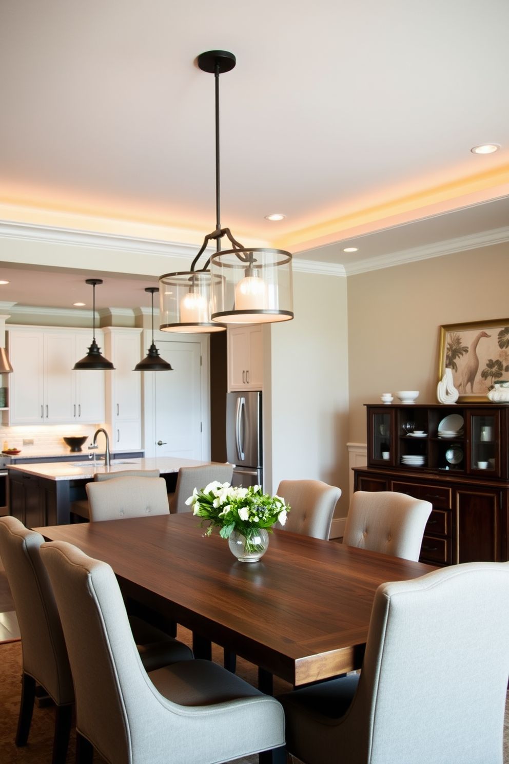 Layered lighting creates a warm and inviting atmosphere in the kitchen dining room. Pendant lights hang above the dining table, while recessed lighting illuminates the kitchen workspace for both functionality and style. The dining area features a large wooden table surrounded by upholstered chairs, creating a cozy yet elegant setting. A sideboard against the wall showcases decorative items and provides additional storage, enhancing the overall design.