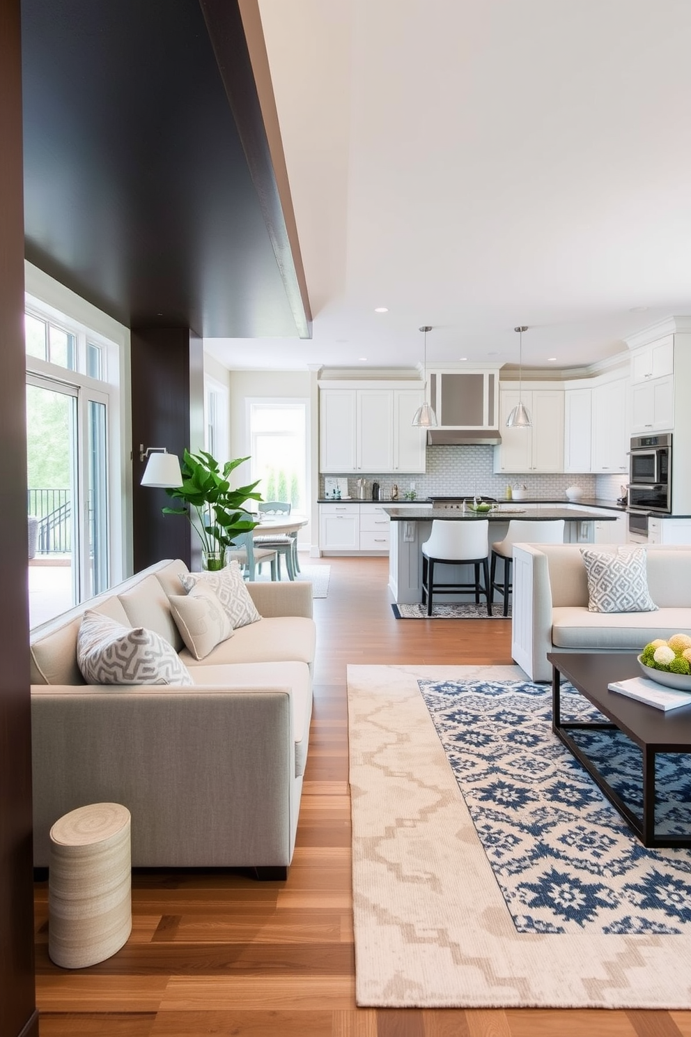 A spacious kitchen family room combo features a large area rug in a soft beige tone that defines the seating area. The rug is layered over hardwood floors, creating a cozy atmosphere while complementing the modern furniture and decor. In the kitchen area, a contrasting patterned rug adds visual interest and separates the cooking space from the dining zone. This design choice enhances the flow of the open concept while providing comfort underfoot.