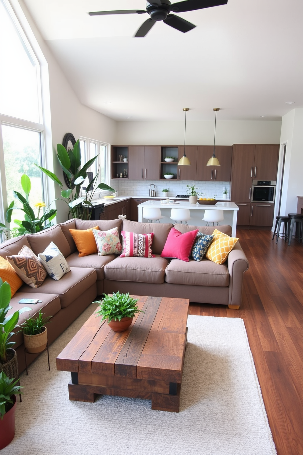 A cozy family room that seamlessly integrates with the kitchen. The space features a large sectional sofa adorned with colorful throw pillows, paired with a rustic coffee table made of reclaimed wood. In one corner, a collection of indoor plants in various sizes adds a fresh and vibrant atmosphere. The kitchen showcases sleek cabinetry with a modern island that includes barstool seating for casual dining.