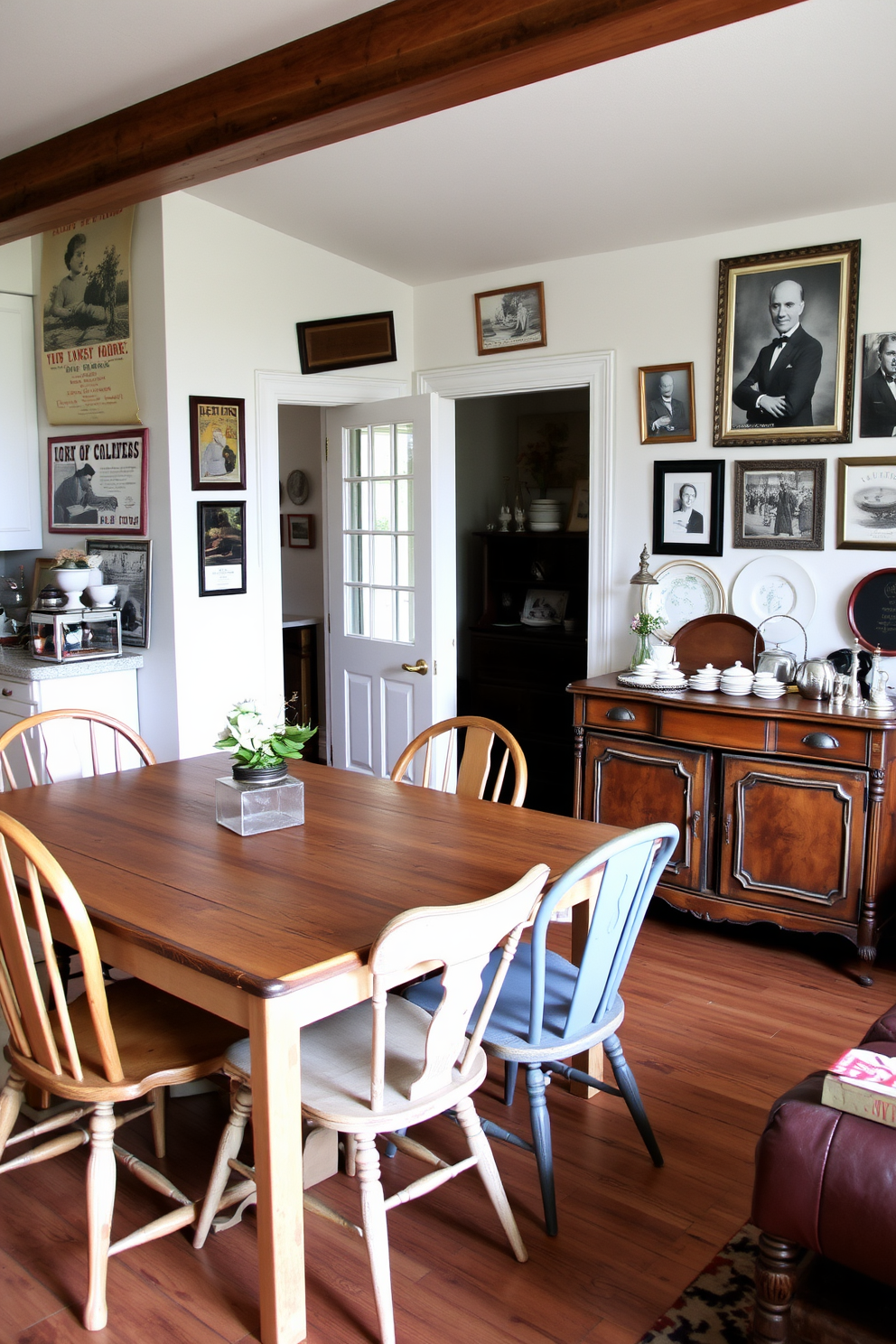 A cozy kitchen family room combo featuring vintage decor elements. The space includes a rustic wooden dining table surrounded by mismatched antique chairs, creating a warm and inviting atmosphere. On the walls, vintage posters and framed black-and-white photographs add character and charm. A vintage sideboard displays an assortment of decorative dishes and heirlooms, enhancing the nostalgic feel of the room.