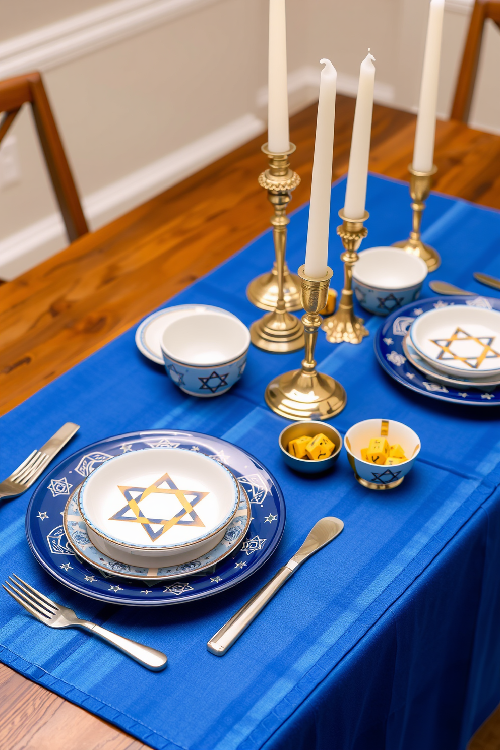 A festive Hanukkah-themed dishware set is beautifully arranged on a wooden dining table. The dishware features a rich blue and white color palette with Star of David motifs and menorah designs, complemented by shiny silver utensils. The table is adorned with a vibrant table runner in deep blue, accented by gold candles in elegant holders. Decorative dreidels and small bowls filled with gelt add a playful touch to the overall Hanukkah decorating theme.