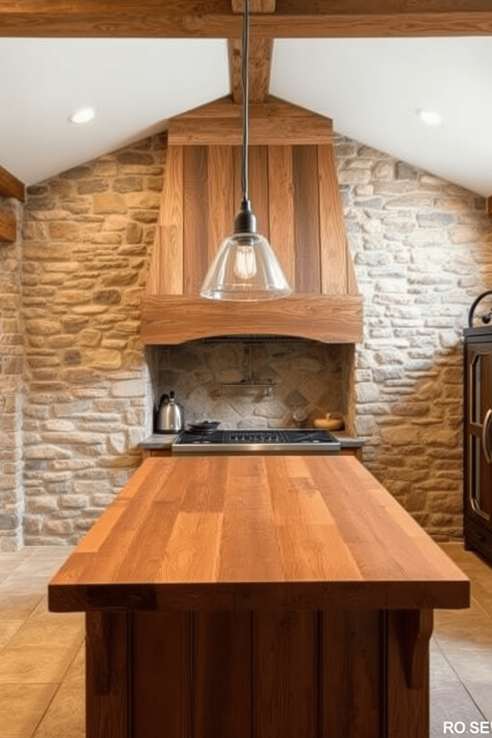 A rustic kitchen featuring stone cladding on the walls, creating a warm and inviting atmosphere. The design includes a large kitchen hood made of reclaimed wood, complementing the natural textures of the stone. The kitchen island is topped with a thick wooden countertop, providing a contrast to the stone surfaces. Pendant lights hang above the island, adding a touch of modern elegance to the rustic design.