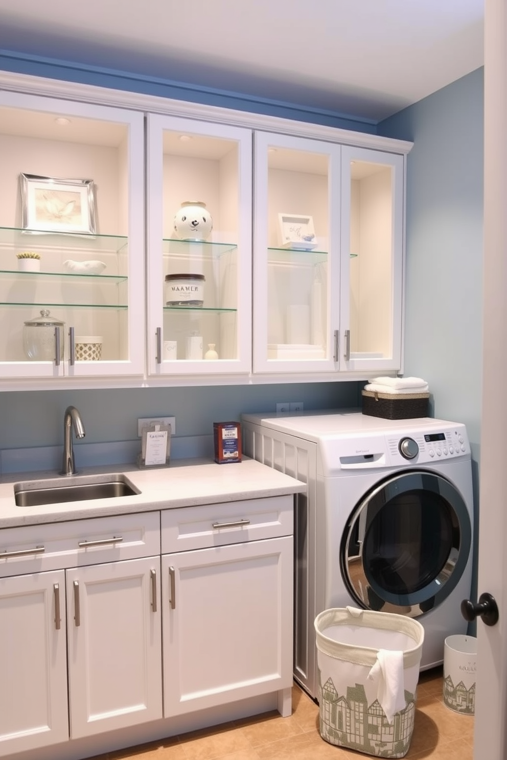 A stylish laundry room featuring glass-front cabinets that showcase neatly arranged display items. The cabinets are complemented by a sleek countertop and modern appliances, creating a functional yet aesthetically pleasing space. The walls are painted in a soft blue hue, enhancing the serene atmosphere of the room. A stylish laundry basket and decorative storage bins add charm and organization to the design.