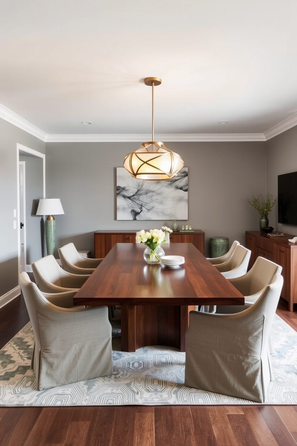 A stylish L-shaped dining room features a sleek wooden dining table surrounded by upholstered chairs in a neutral fabric. Above the table, a striking statement light fixture with an artistic design illuminates the space, creating a warm and inviting atmosphere. The walls are painted in a soft gray, complementing the rich tones of the wood. A large area rug anchors the dining area, adding texture and warmth to the room while a sideboard against one wall provides additional storage and display space.