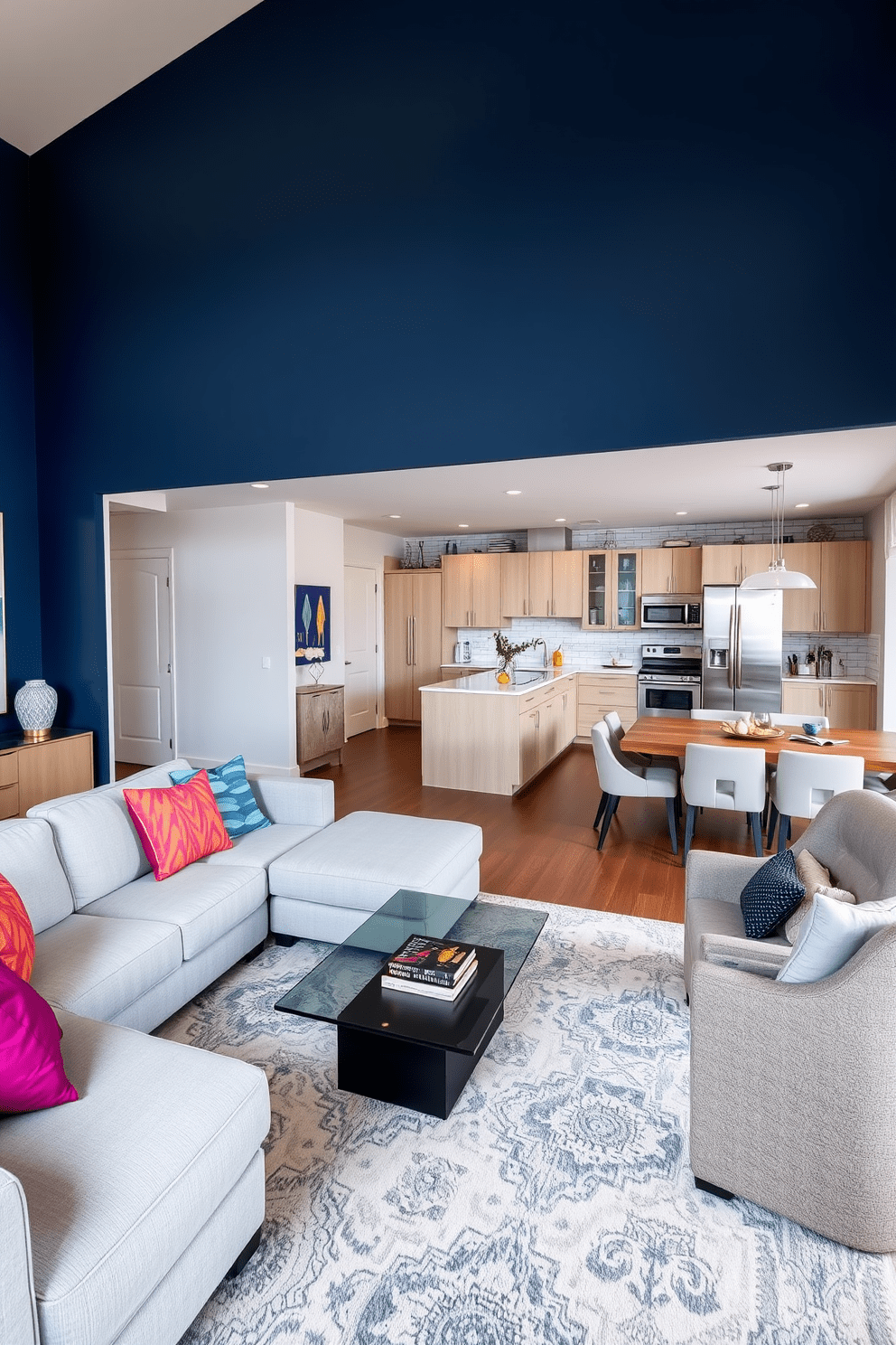 A large apartment design featuring an open concept living area with a bold accent wall painted in deep navy blue. The space includes a plush sectional sofa in a light gray fabric, complemented by vibrant throw pillows and a sleek glass coffee table in the center. Adjacent to the living area, a modern kitchen boasts high-end stainless steel appliances and a spacious island with bar seating. The dining area features a stylish wooden table surrounded by upholstered chairs, creating an inviting atmosphere for entertaining guests.