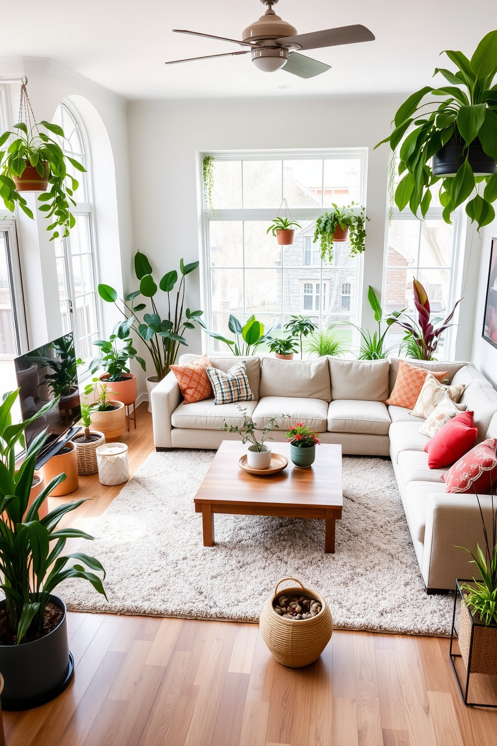 A spacious family room filled with natural light and adorned with various indoor plants. The plants are strategically placed in stylish pots around the room, creating a fresh and vibrant atmosphere. The seating area features a large sectional sofa in a neutral tone, complemented by colorful throw pillows. A wooden coffee table sits in the center, surrounded by a soft area rug that adds warmth to the space.