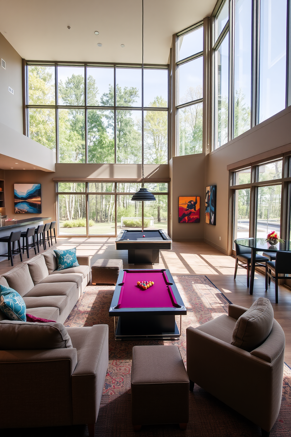 A spacious game room with large windows allowing abundant natural light to flood the space. The room features a plush sectional sofa arranged around a sleek coffee table, creating an inviting atmosphere for entertainment. In one corner, a custom-built bar with high stools offers a spot for refreshments. The walls are adorned with vibrant artwork, and a pool table takes center stage, surrounded by comfortable seating.