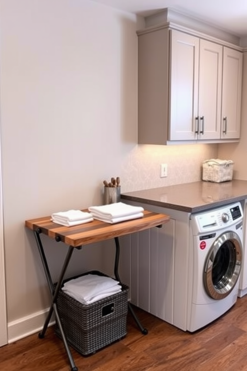 A stylish folding table is positioned against the wall, crafted from reclaimed wood with a sleek metal frame. The table is adorned with neatly folded linens and a couple of decorative baskets for added storage. The large laundry room features ample cabinetry with a modern finish, providing plenty of space for organization. A spacious countertop extends over the washer and dryer, perfect for folding clothes and sorting laundry.