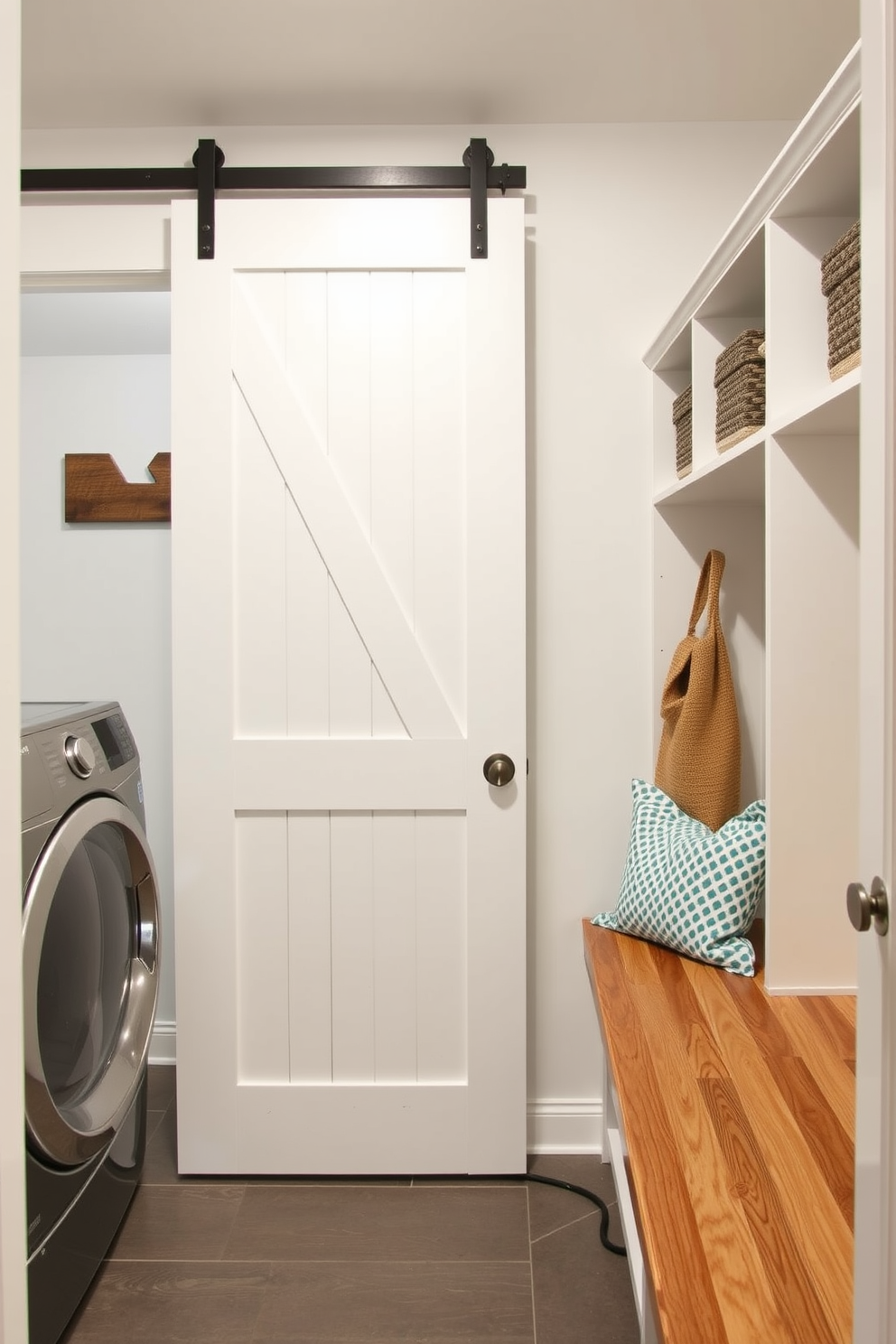 A functional laundry mudroom features a sliding barn door that seamlessly separates the space from the rest of the home. The room is equipped with built-in shelving for storage and a bench for convenience, creating an organized and inviting area.