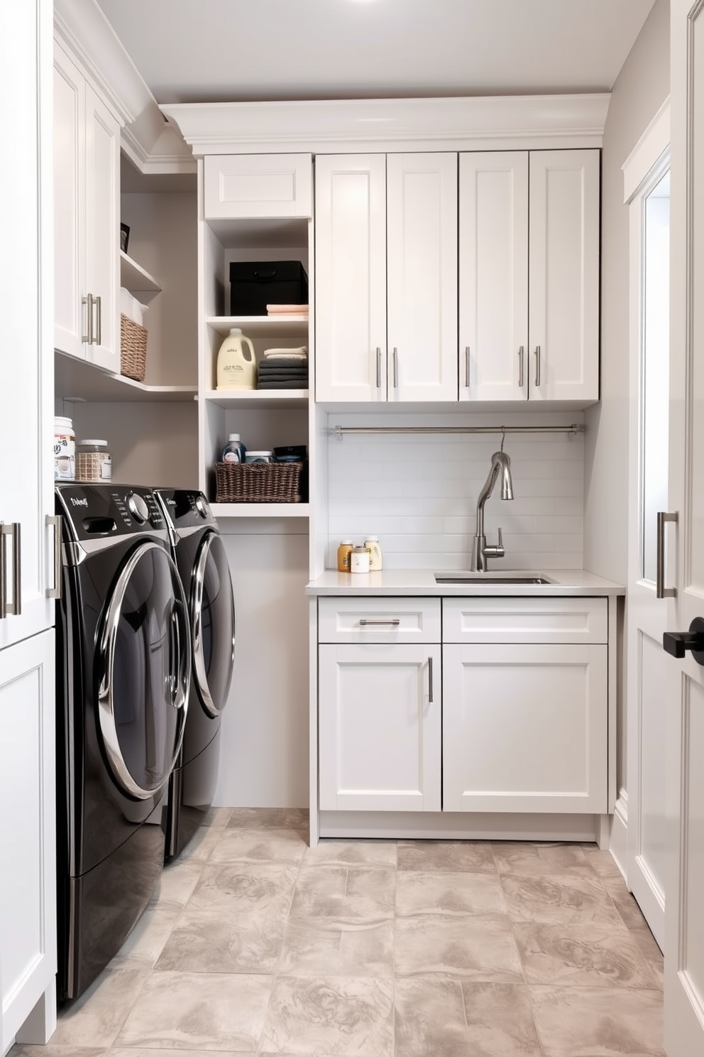 Built-in cabinets line the walls of the laundry mudroom, providing ample organized storage for cleaning supplies and household items. The cabinetry features a sleek white finish with brushed nickel hardware, creating a modern and functional space. A spacious countertop extends above the cabinets, ideal for folding laundry and sorting items. The floor is adorned with durable ceramic tiles in a soft gray hue, complementing the overall design while ensuring easy maintenance.