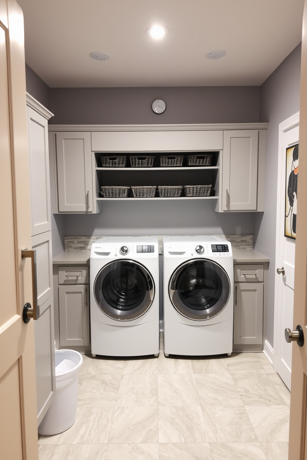 A functional laundry room in the basement features a folding table positioned for convenience and efficiency. The space is illuminated by bright overhead lights, enhancing the clean lines of the cabinetry and the organized layout. The walls are painted in a soft gray, creating a calming atmosphere while the floor is covered with durable vinyl tiles for easy maintenance. Shelving above the folding table holds neatly organized baskets, and a stylish backsplash adds a touch of elegance to the overall design.