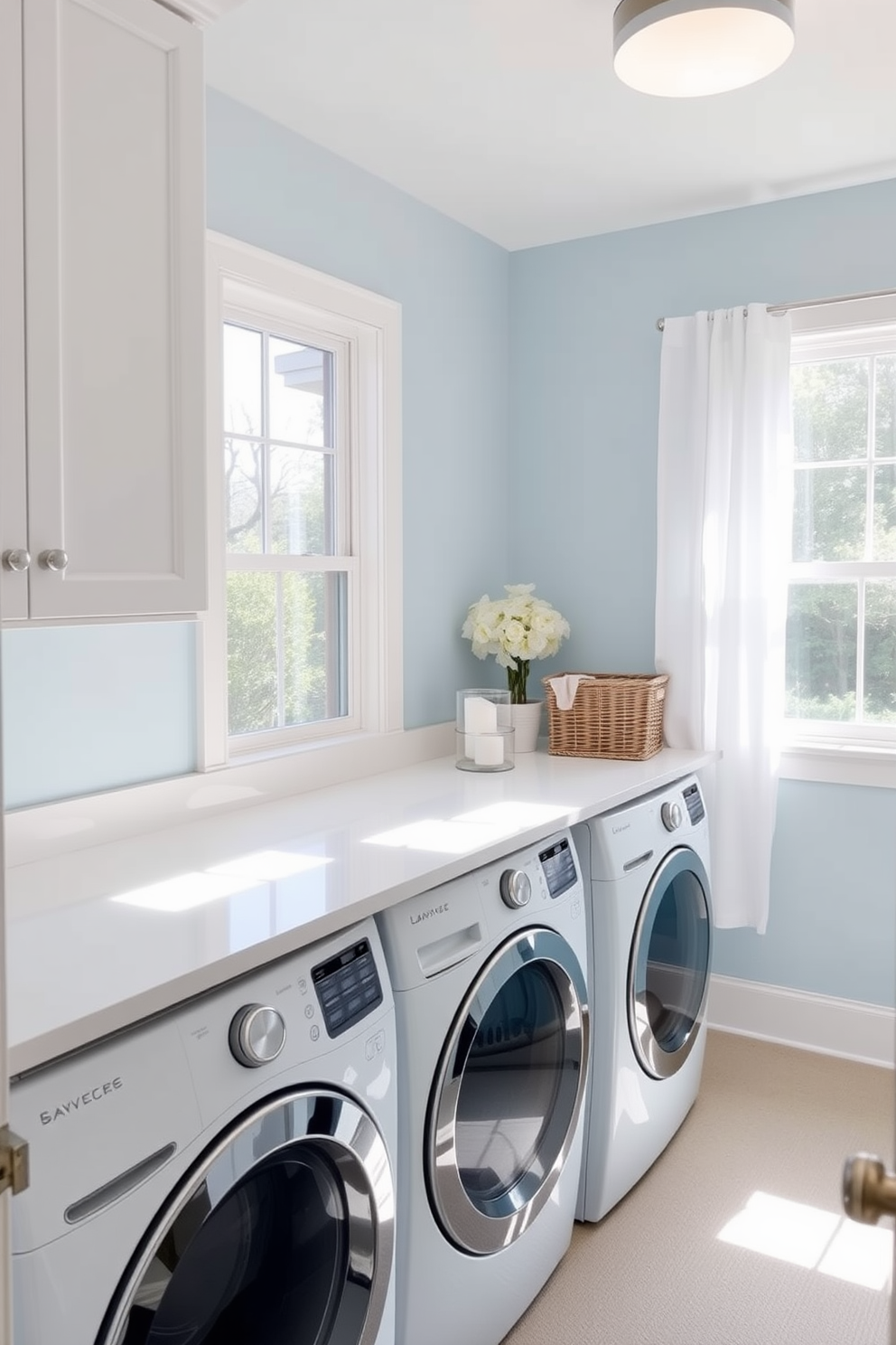 A serene laundry room designed in soft blues and whites. The walls are painted in a light sky blue, creating a tranquil atmosphere, while the cabinetry is a crisp white with brushed nickel hardware. A spacious countertop made of white quartz provides ample space for folding clothes, and a stylish wicker basket sits nearby for sorting laundry. Natural light floods the room through a large window adorned with sheer white curtains, enhancing the calming vibe.