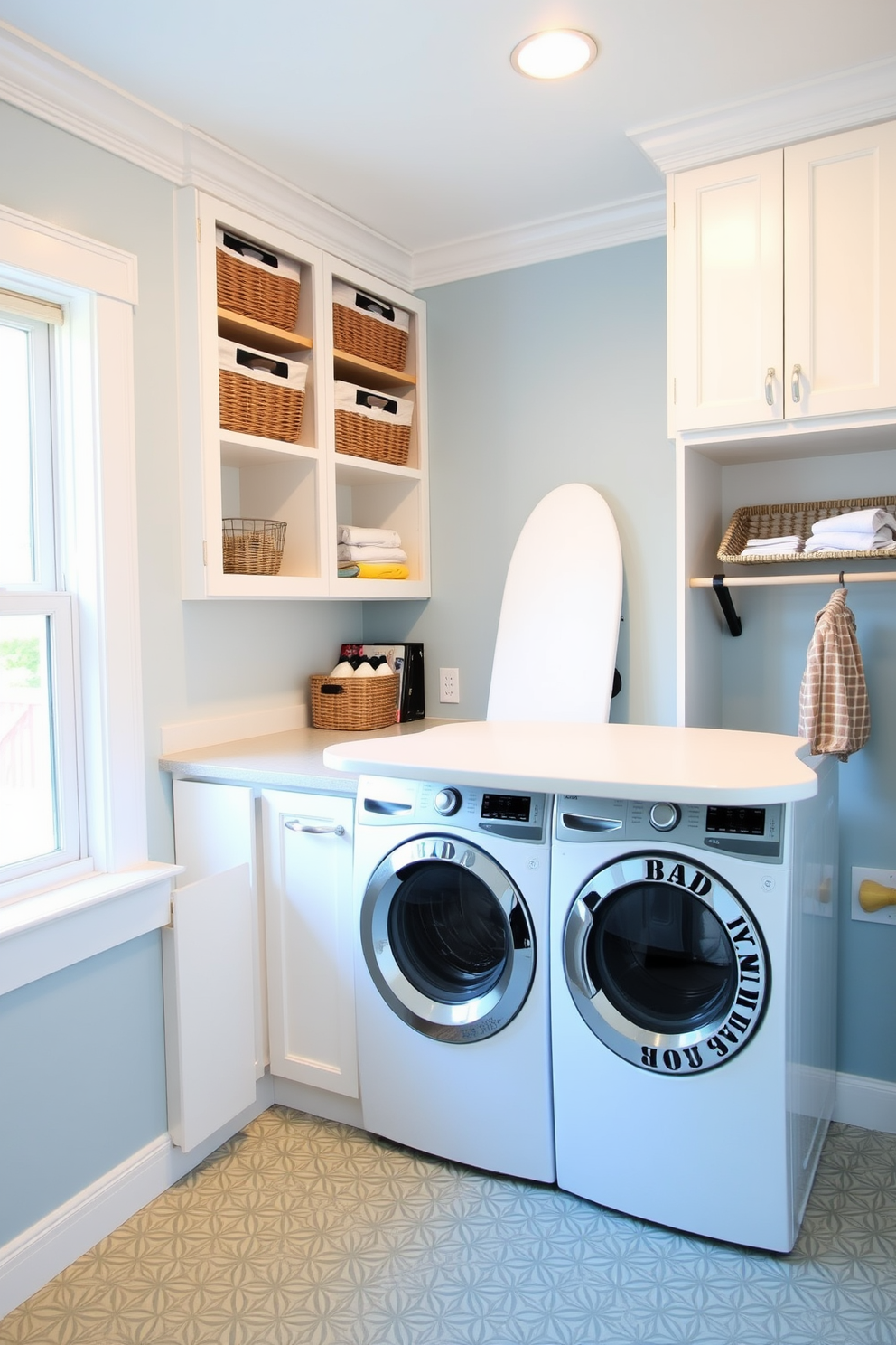 A functional laundry room featuring a built-in ironing board station seamlessly integrated into a custom cabinetry design. The space is bright and airy with white shaker cabinets and a large window that allows natural light to flood in. A countertop extends above the washer and dryer for folding clothes, adorned with stylish storage baskets for organization. The walls are painted in a soft blue hue, and the floor is covered in a durable, patterned vinyl that adds a touch of charm.