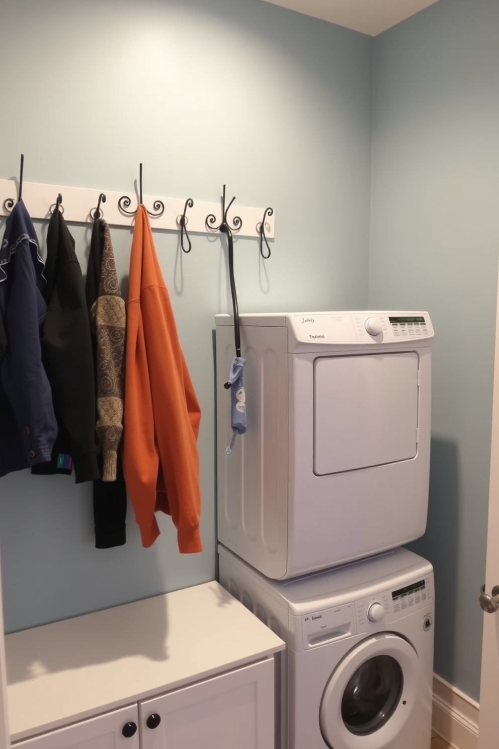 A functional laundry room featuring decorative hooks mounted on the wall for easy clothing access. The space includes a stacked washer and dryer setup, maximizing efficiency and allowing for ample storage options below.