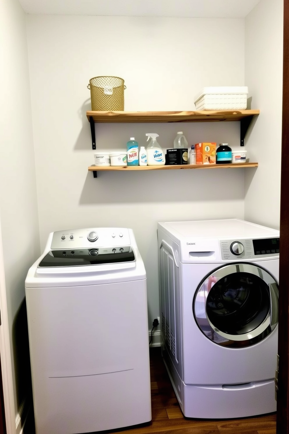 A functional laundry room featuring a top loading washer positioned against a wall. Above the washer, there are open shelves made of reclaimed wood for convenient storage of detergents and laundry supplies.