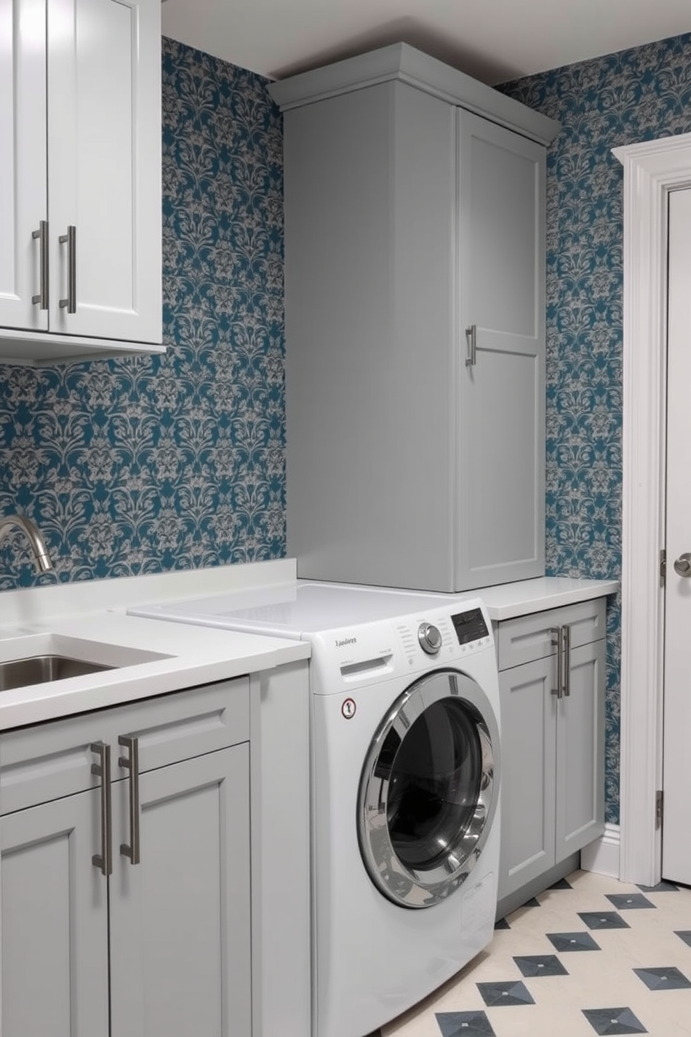 A stylish laundry room featuring patterned wallpaper that adds visual interest to the space. The room includes a top loading washer, surrounded by sleek cabinetry for storage and organization.