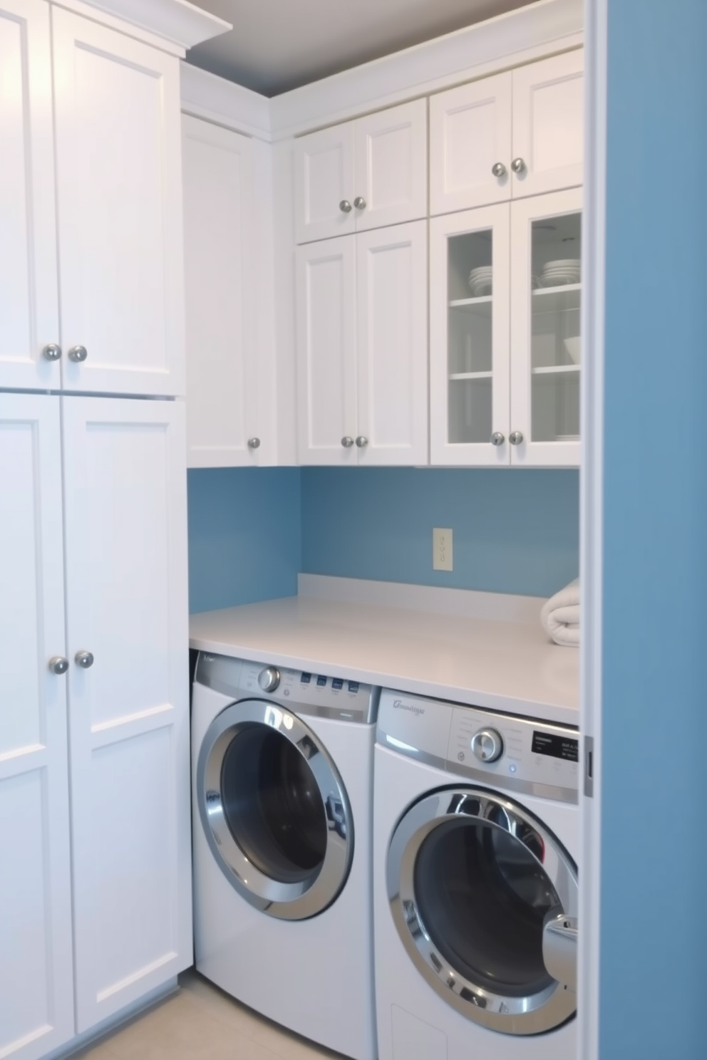 A bright and functional laundry room features a top loading washer positioned next to a spacious countertop designed for folding clothes. The walls are painted in a soft blue hue, complemented by white cabinetry that provides ample storage for laundry essentials.