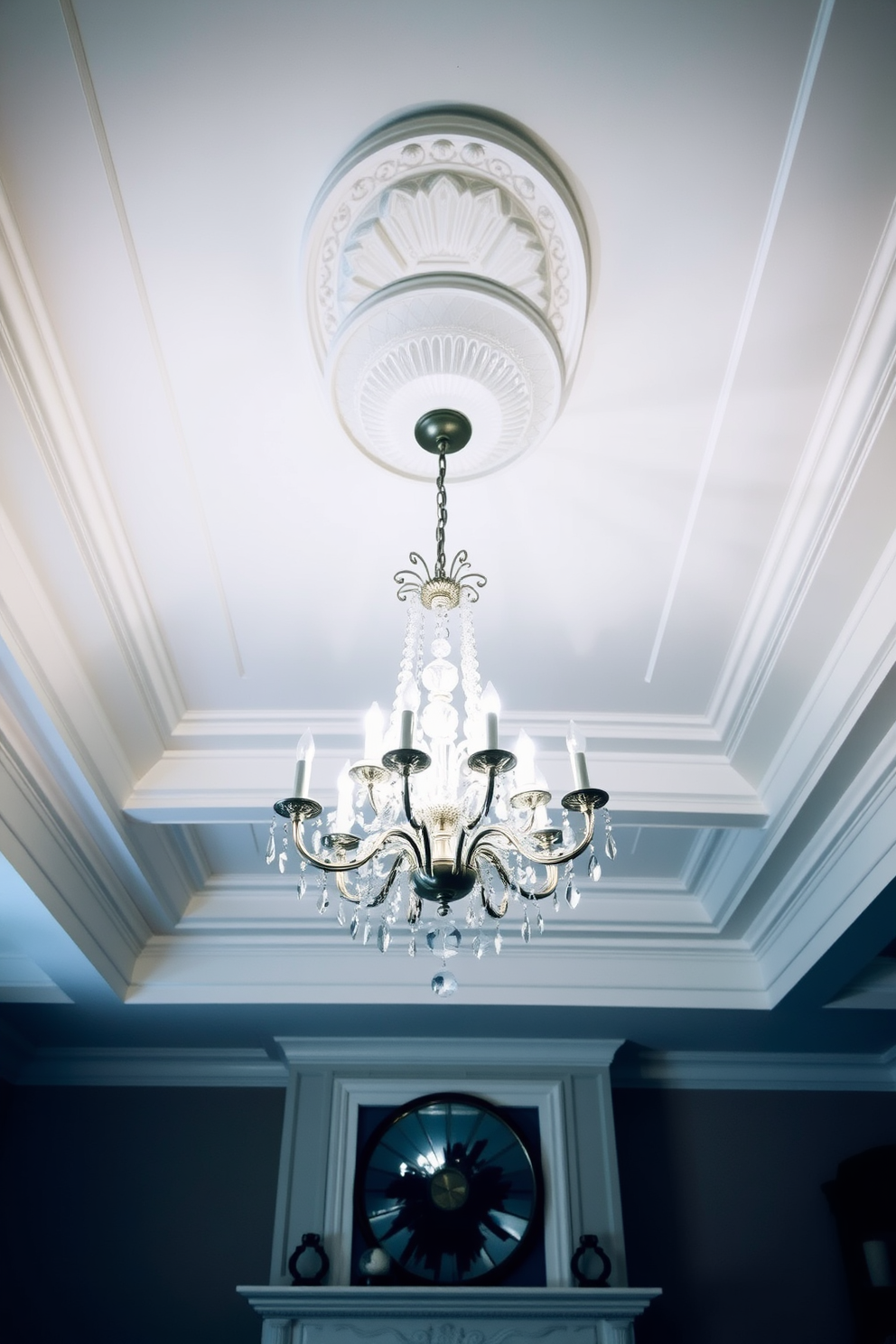 An elegant crystal chandelier hangs gracefully from a beautifully designed tray ceiling in the living room. The soft glow of the chandelier illuminates the space, enhancing the luxurious atmosphere and highlighting the intricate details of the ceiling design.