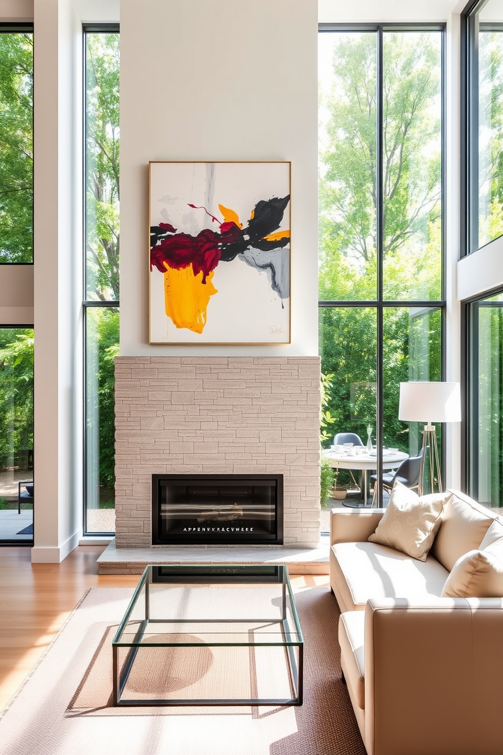 A modern fireplace with a sleek, minimalist design serves as the focal point of the living room. It is surrounded by a simple stone facade, and above it hangs a large piece of abstract art that adds a pop of color to the space. The living room features a low-profile sectional sofa in a neutral tone, paired with a glass coffee table that reflects the natural light. Large windows frame the room, allowing for ample sunlight and offering a view of the lush greenery outside.