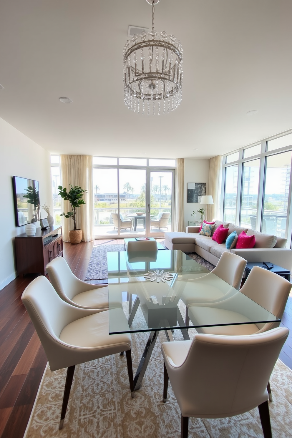 A spacious living room dining room combo features a sleek glass dining table surrounded by modern upholstered chairs. The airy feel is enhanced by large windows that allow natural light to flood the space, creating an inviting atmosphere. The living area showcases a plush sectional sofa adorned with vibrant throw pillows, positioned to encourage conversation. A stylish area rug anchors the seating arrangement, while a statement chandelier adds a touch of elegance overhead.