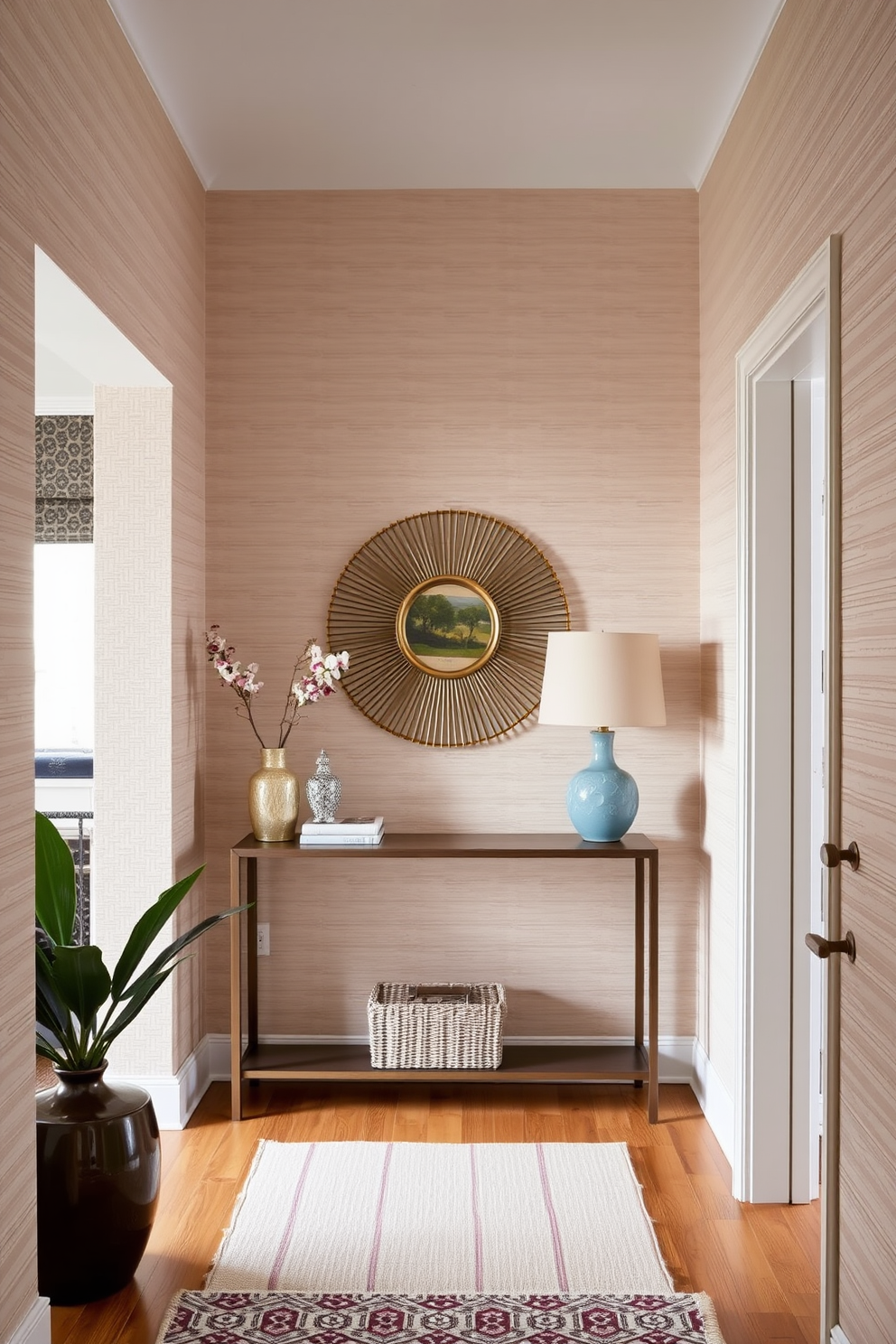 A cozy living room entryway features textured wallpaper that adds depth and warmth to the space. The walls are adorned with a subtle pattern in soft neutral tones, complemented by a stylish console table and a decorative mirror above it.