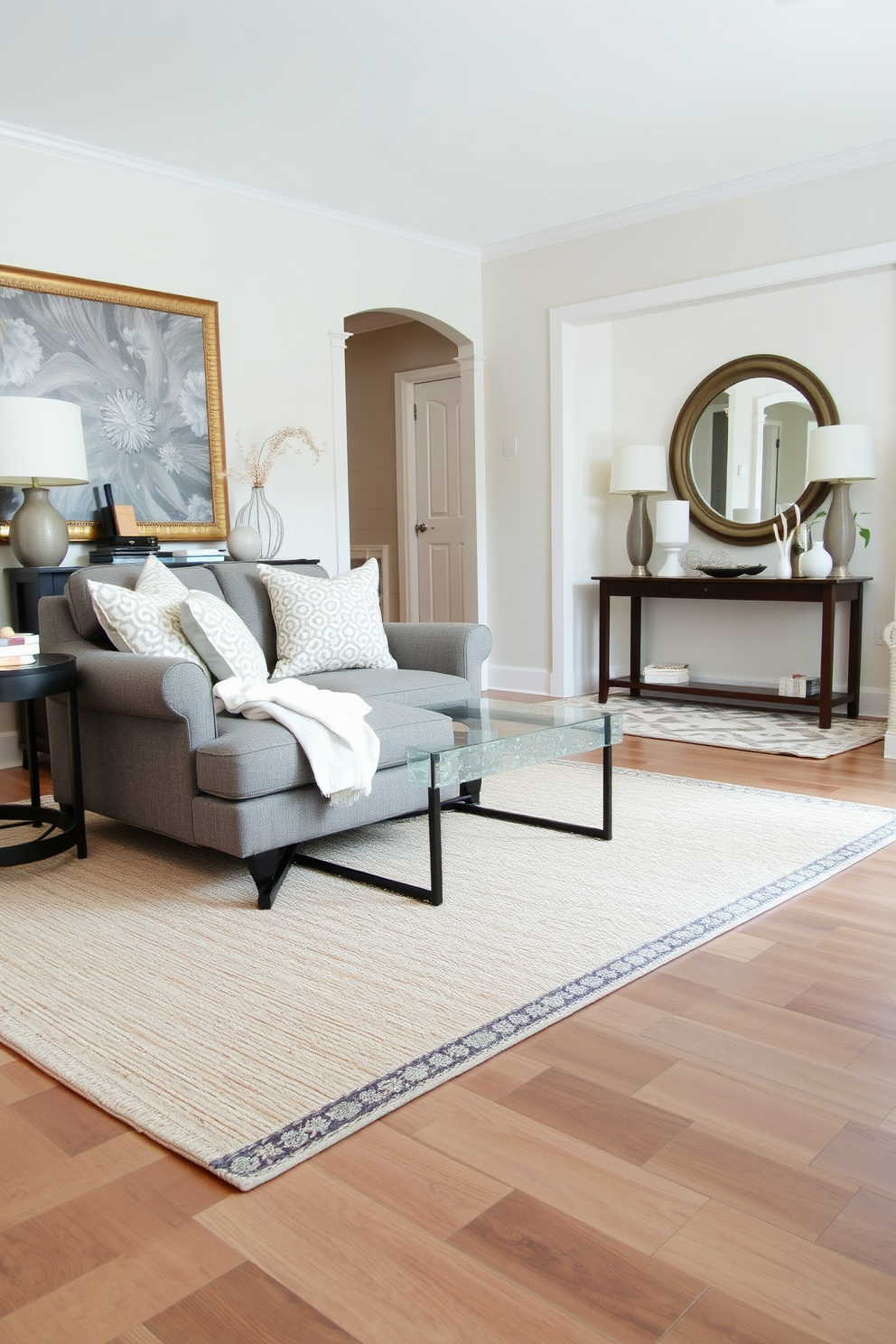 A cozy living room featuring layered rugs that add texture and warmth. The base rug is a large neutral tone while a smaller patterned rug sits on top, creating a stylish focal point. The entryway showcases a blend of functionality and aesthetics. A console table with decorative items is flanked by a large mirror, and a soft rug welcomes guests at the entrance.