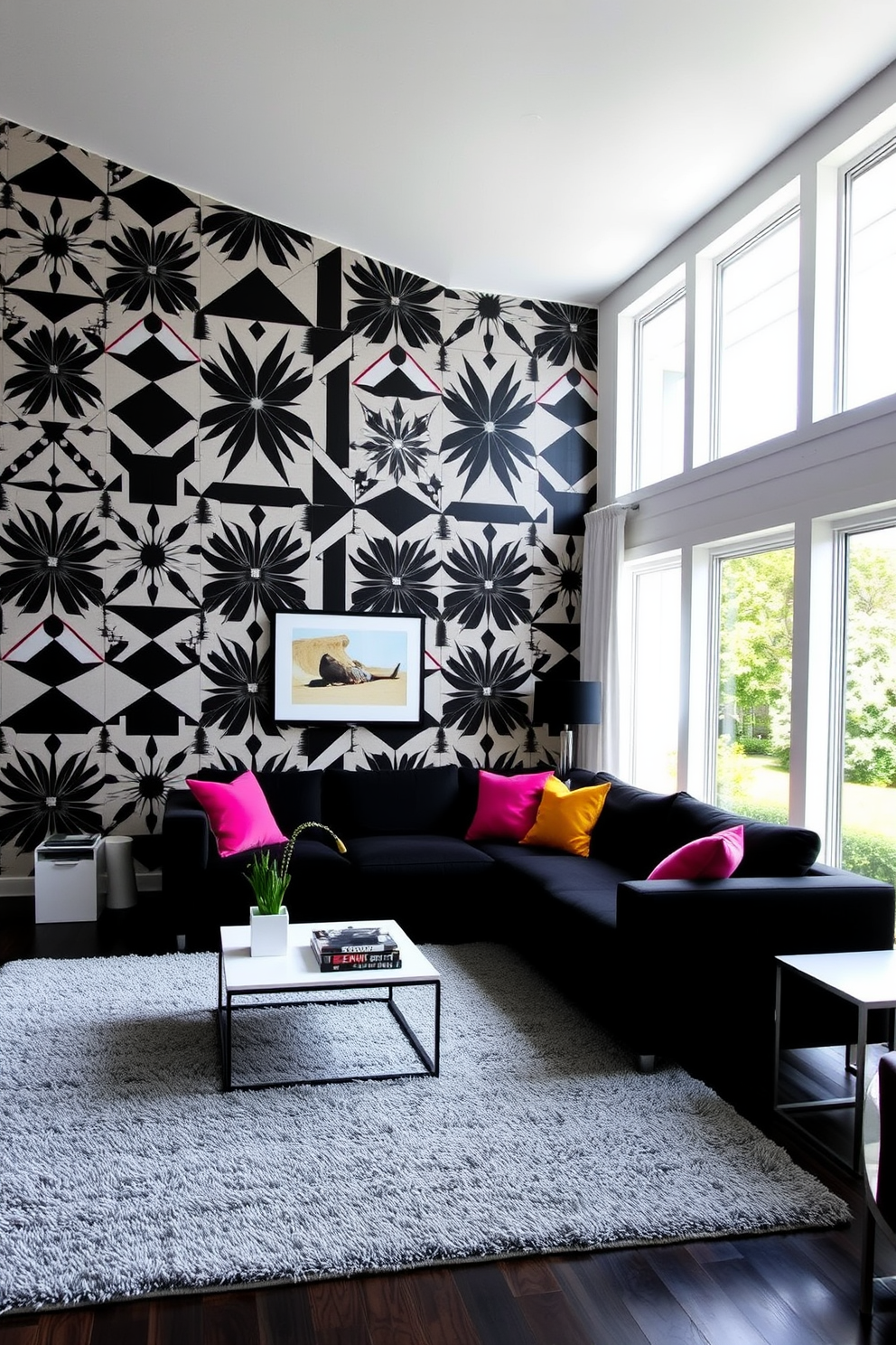 A striking living room adorned with bold black and white wallpaper featuring geometric patterns that create a dramatic focal point. The furniture is minimalist, with a sleek black sofa and a white coffee table, complemented by vibrant throw pillows that add a pop of color. Large windows allow natural light to flood the space, highlighting the contrast between the dark wallpaper and light furnishings. A plush area rug in subtle gray tones anchors the seating area, creating a cozy atmosphere perfect for entertaining.