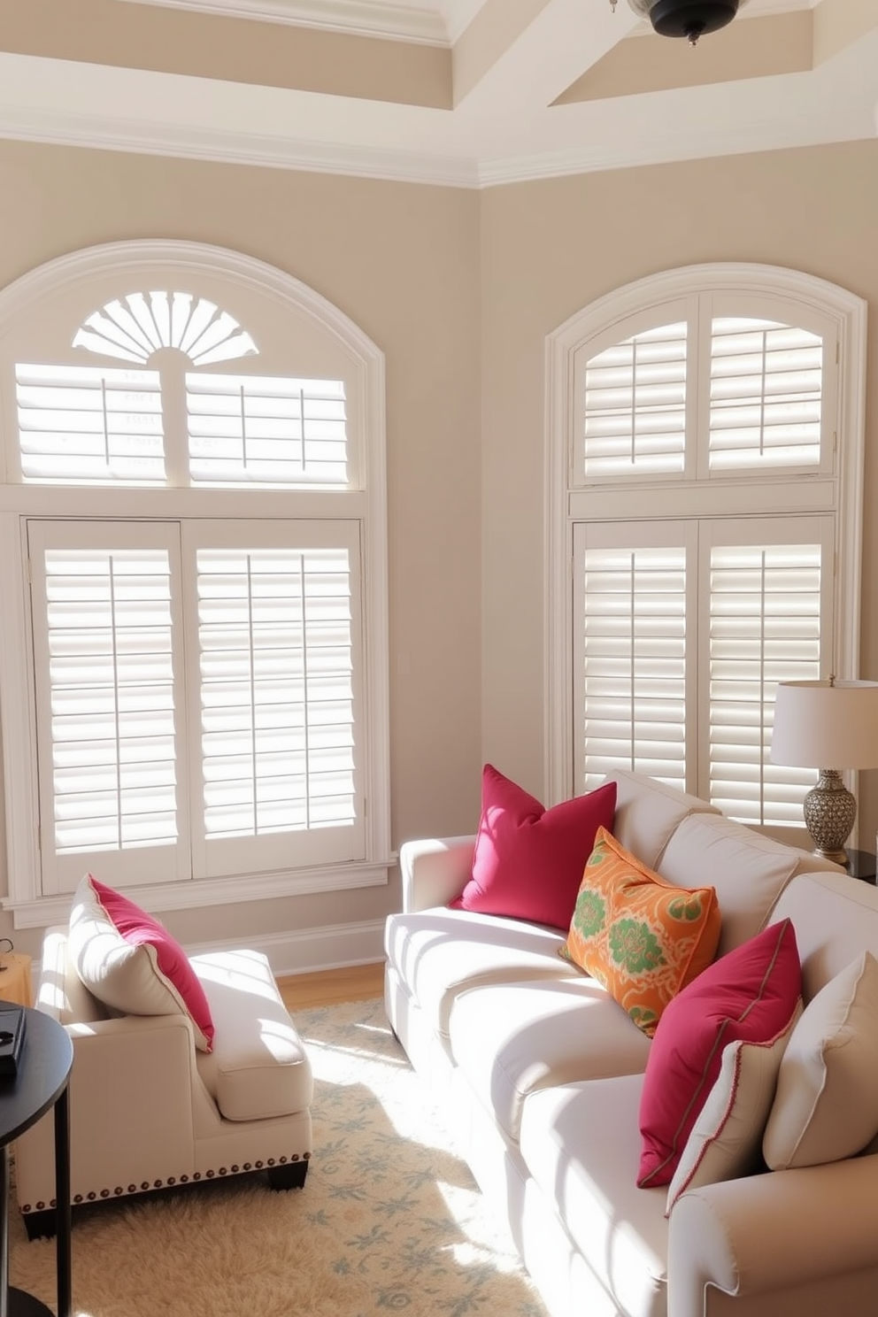 A beautifully designed living room features large windows adorned with elegant plantation shutters that provide both style and functionality. The shutters are painted in a crisp white, allowing natural light to filter through while maintaining privacy. The room is filled with soft, neutral furnishings, complemented by vibrant accent pillows that add a pop of color. A plush area rug anchors the seating arrangement, creating a cozy and inviting atmosphere perfect for relaxation and entertaining.