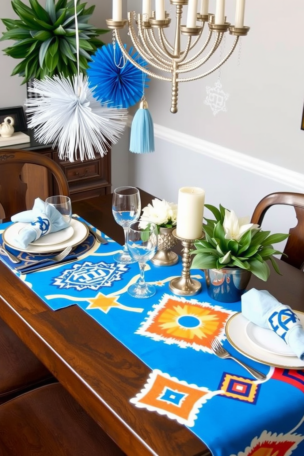 A festive dining table adorned with bold graphic prints on table runners. The runners feature vibrant colors and geometric patterns that contrast beautifully with the elegant tableware. Hanging above the table are decorative elements that reflect the spirit of Hanukkah. Soft blue and silver accents create a warm and inviting atmosphere for family gatherings.