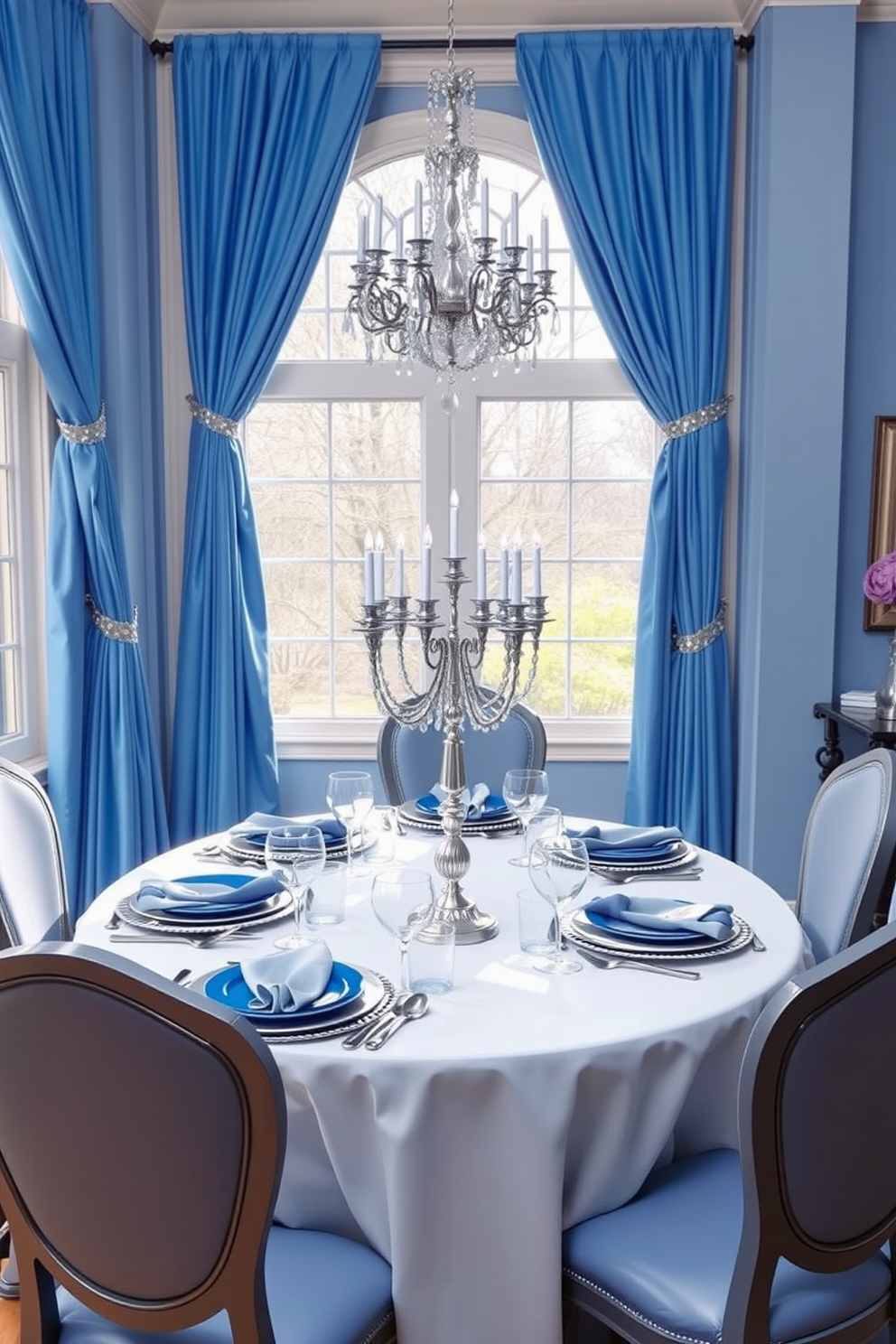 Chic blue and silver color palette. The space features elegant blue accents with shimmering silver decorations that create a festive atmosphere for Hanukkah. Soft blue drapes frame large windows, allowing natural light to illuminate the room. A beautifully set table adorned with silver menorahs and blue tableware enhances the celebratory mood.