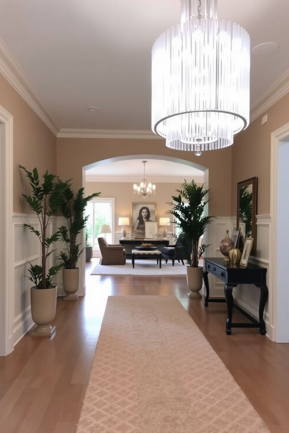 A long foyer features a statement chandelier that serves as a captivating centerpiece. The walls are adorned with elegant wainscoting, while a plush runner rug guides guests toward the main living area. Flanking the entrance, tall potted plants add a touch of greenery and sophistication. A console table against one wall displays art pieces and decorative items, creating a warm and inviting atmosphere.