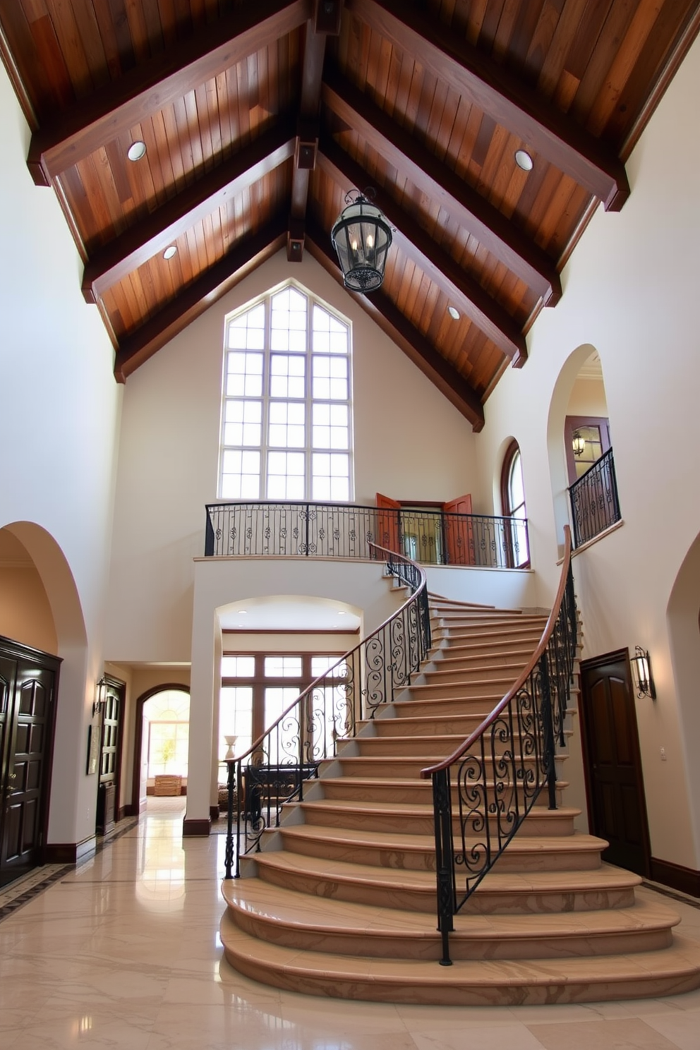 A grand foyer with high ceilings showcasing exposed wooden beams. Elegant marble flooring leads to a sweeping staircase adorned with a wrought iron railing, creating a stunning first impression.