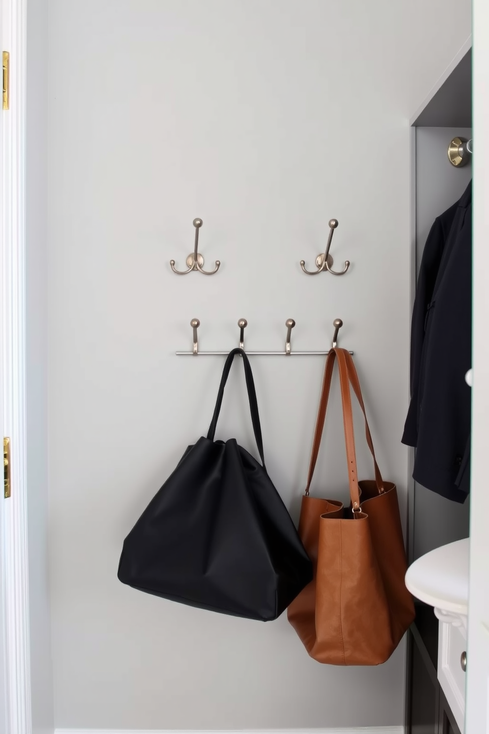 A master bedroom walk-in closet featuring elegant wall-mounted hooks for bags. The hooks are stylishly arranged along a soft gray wall, providing easy access while adding a touch of sophistication to the space.