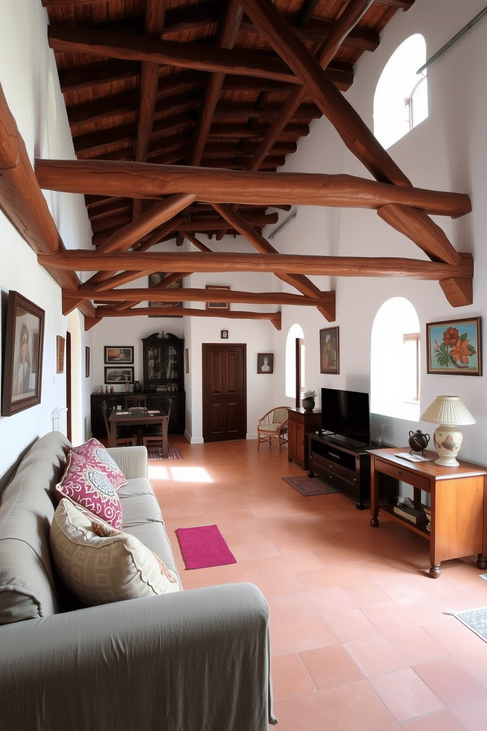 A Mediterranean apartment with exposed wooden beams that add rustic charm. The open living space features terracotta tile floors and whitewashed walls adorned with vibrant artwork.