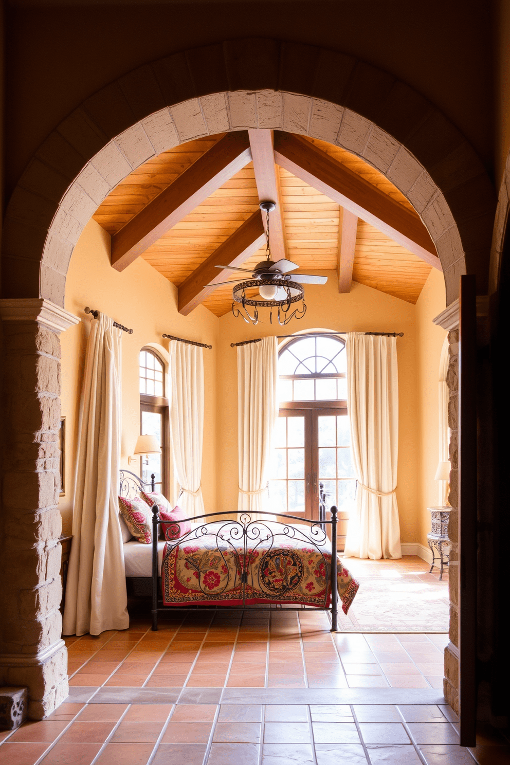 Mediterranean style archways and doorways feature intricate stonework and warm earthy tones. The arches are often adorned with decorative tiles and wrought iron accents, creating a welcoming and elegant entryway. For a Mediterranean bedroom design, envision a spacious layout with a wooden beam ceiling and terracotta tiles. Soft linen drapes frame large windows that allow natural light to flood the room, complemented by a wrought iron bed with colorful patterned bedding.