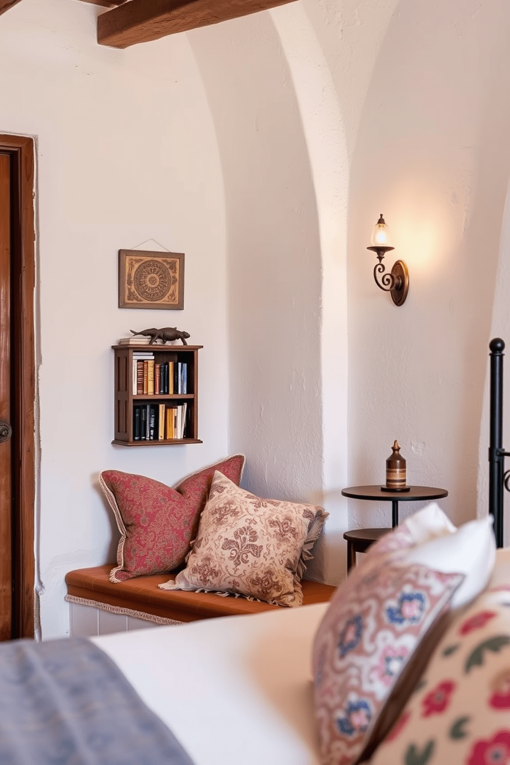 Cozy nook with plush cushions. Soft, warm lighting creates an inviting atmosphere, while a small bookshelf filled with books adds charm. Mediterranean bedroom design ideas. Whitewashed walls and terracotta tiles provide a rustic backdrop, complemented by colorful textiles and wrought iron accents.