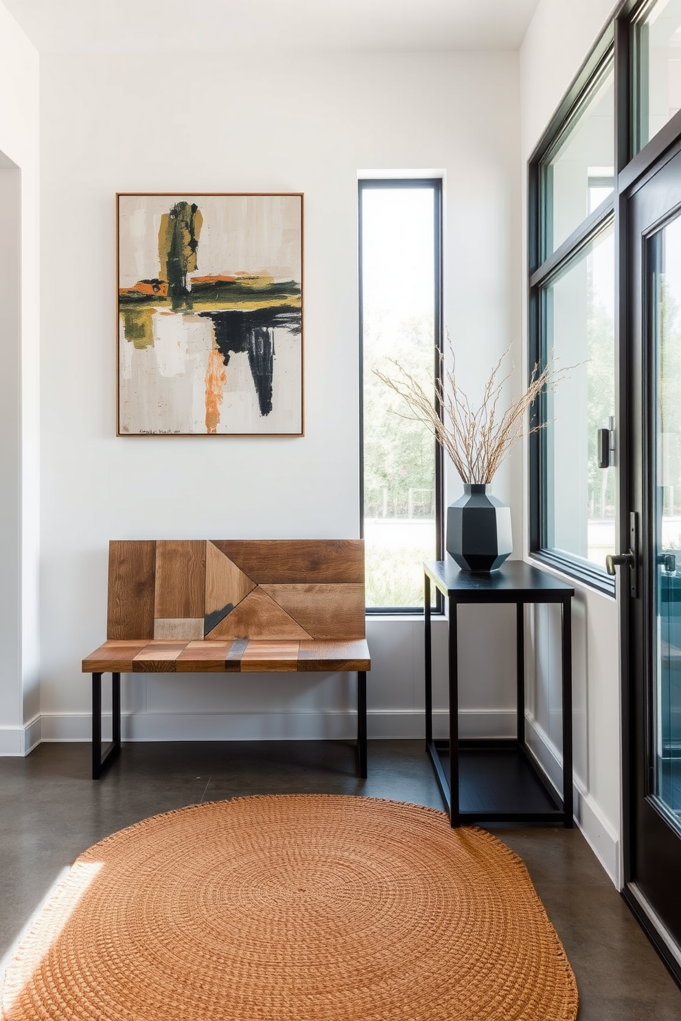 A welcoming foyer that combines rustic elements with sleek lines. The space features a reclaimed wood bench against a white wall, complemented by a minimalist black console table adorned with a geometric vase. Natural light floods the area through a large window, illuminating a woven rug that adds warmth to the polished concrete floor. A statement piece of abstract art hangs above the bench, bridging the gap between modern elegance and rustic charm.