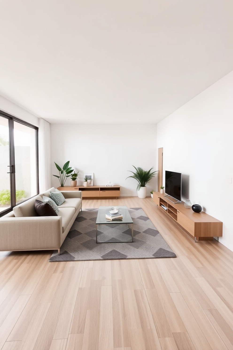 A minimalist family room featuring sleek modern furniture designs. The space includes a low-profile sectional sofa in a neutral color, paired with a glass coffee table and a geometric area rug. A large window allows natural light to flood the room, highlighting the clean lines and open layout. A simple entertainment unit with a flat-screen TV sits against one wall, complemented by a few potted plants for a touch of greenery.