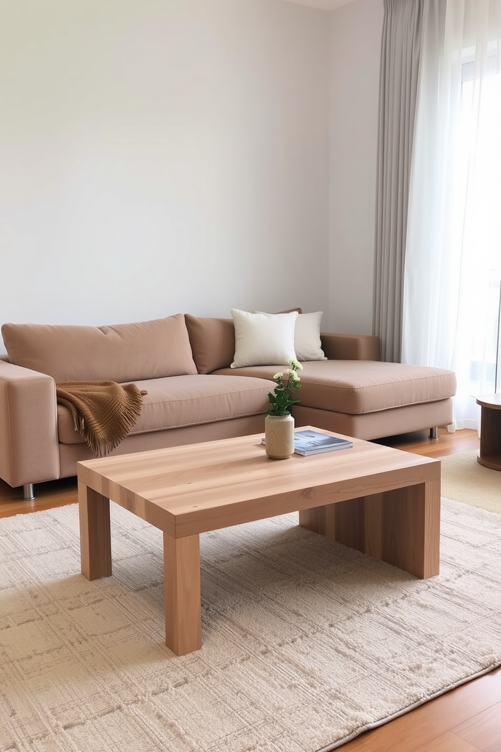 A minimalist family room features a simple coffee table made of light wood with clean lines and a smooth finish. The seating arrangement consists of a plush sectional sofa in a neutral color, complemented by a soft area rug that adds warmth to the space.