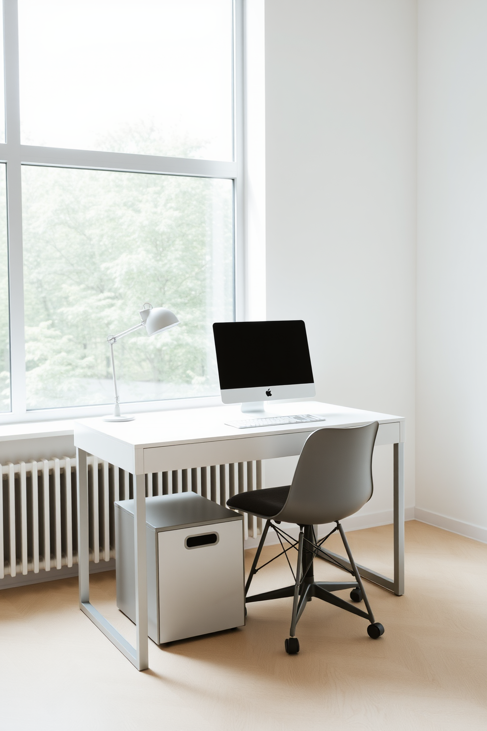 A compact filing cabinet sits neatly under the desk, providing essential storage while maintaining a clean aesthetic. The minimalist home office features a sleek desk with a simple chair, surrounded by soft natural light filtering through a large window.