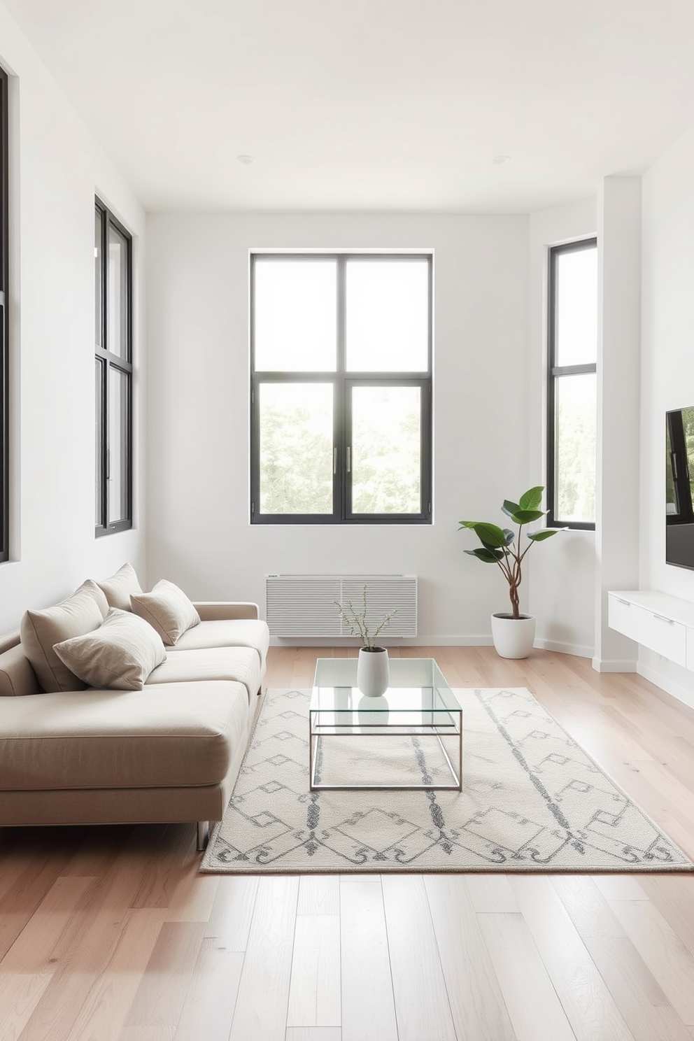 A minimalist living room design featuring a sleek low-profile sofa in a neutral color. The walls are painted white, and the floor is adorned with light hardwood, creating an airy and open atmosphere. A simple coffee table made of glass and metal sits in the center, complemented by a single potted plant in the corner. Large windows allow natural light to flood the space, enhancing the minimalist aesthetic.