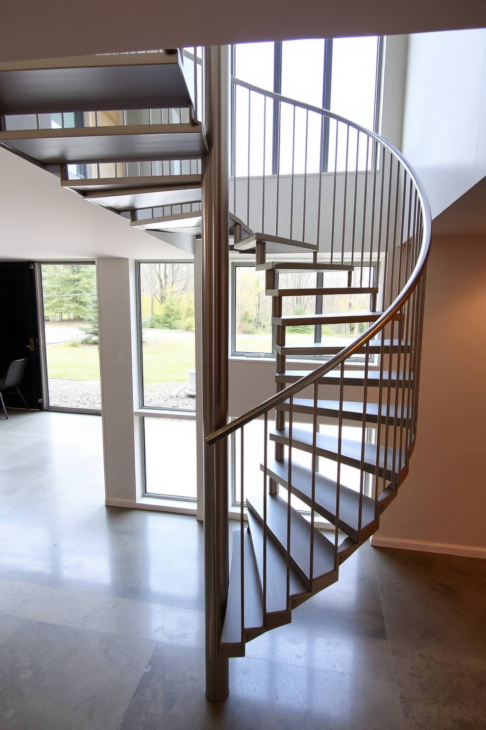 A sleek minimalist metal spiral staircase gracefully ascends to the upper level. The staircase features a brushed steel finish with open risers and a simple handrail, emphasizing a clean and airy aesthetic. The surrounding space is adorned with neutral tones and large windows that allow natural light to flood in. A polished concrete floor complements the modern design, creating a seamless flow throughout the area.