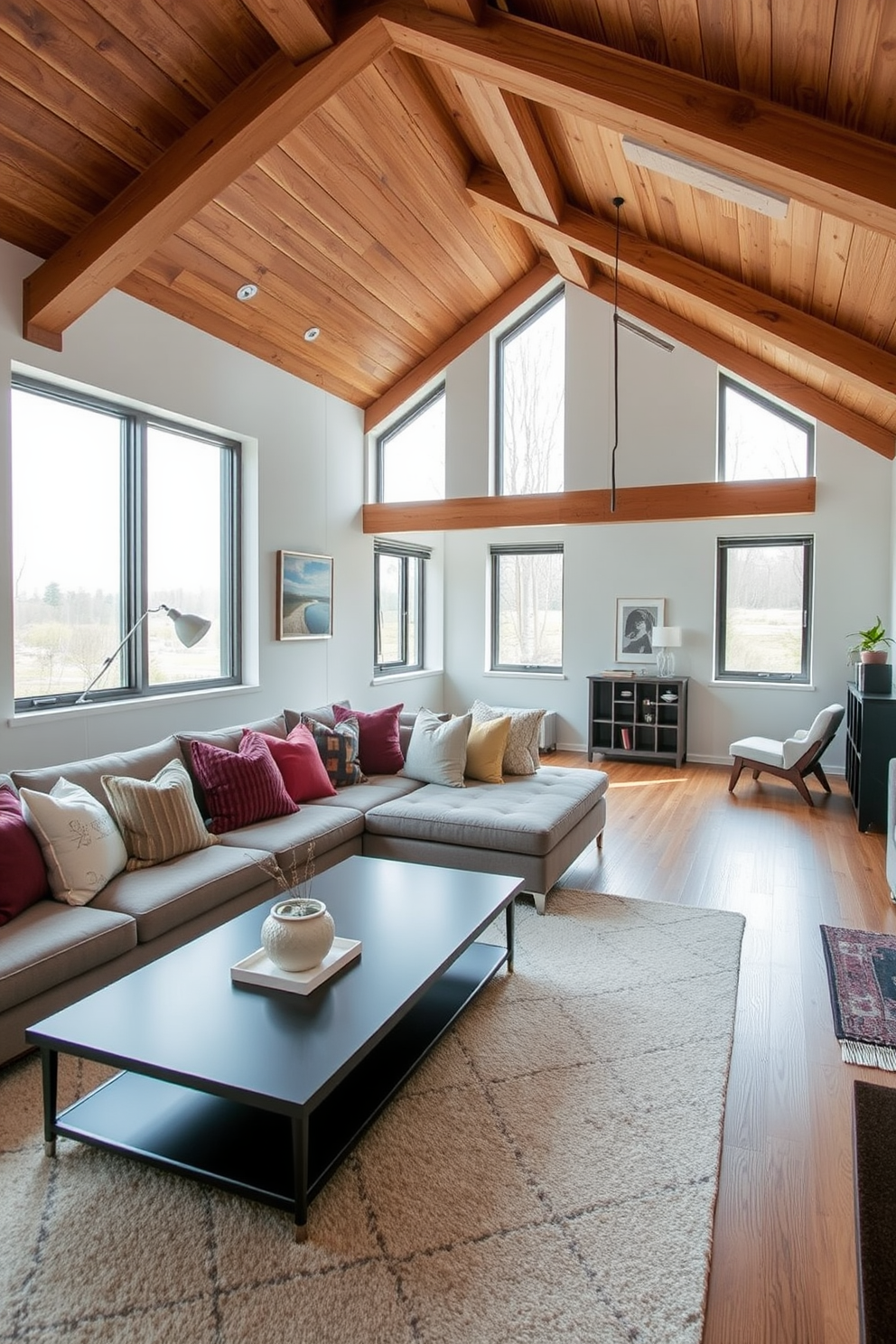 A contemporary lounge area features a large sectional sofa adorned with plush cushions in various textures and colors. A sleek coffee table sits in front, complemented by a stylish area rug that adds warmth to the space. For modern attic design ideas, the room boasts exposed wooden beams that enhance the airy feel. Large windows allow natural light to flood in, illuminating a cozy reading nook with a comfortable chair and a small bookshelf.