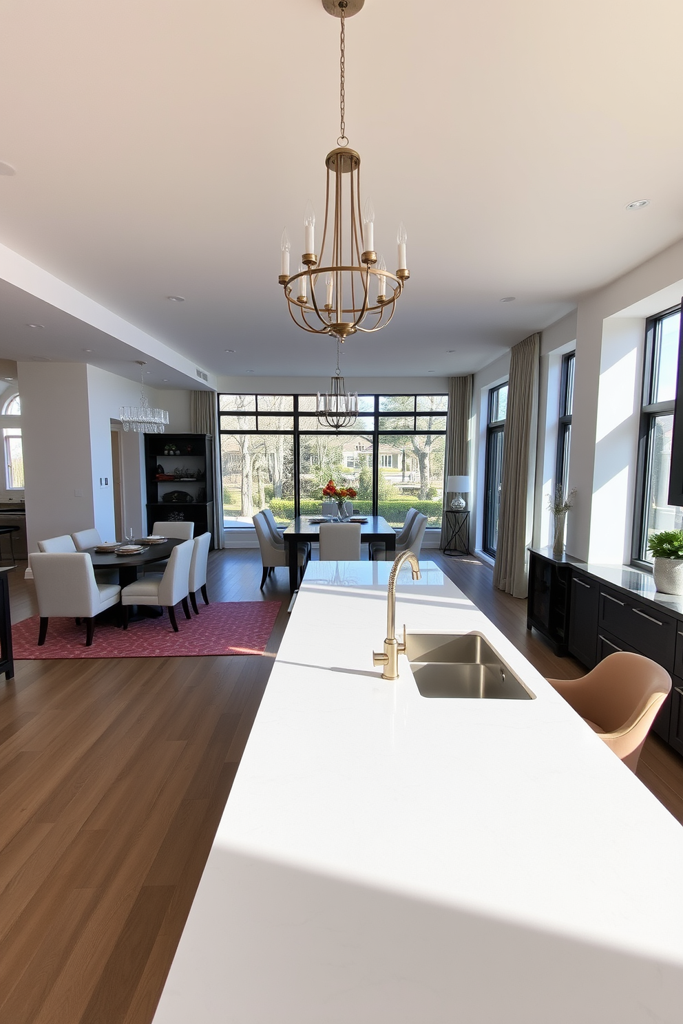 A spacious open concept dining area seamlessly connects to a sleek kitchen island. The dining table is surrounded by elegant upholstered chairs, and a statement chandelier hangs above, casting a warm glow over the space. The kitchen island features a polished quartz countertop with stylish bar stools on one side. Natural light floods the room through large windows, highlighting the contemporary decor and inviting atmosphere.