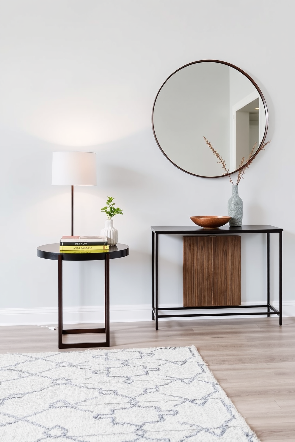 An elegant side table is positioned against a light gray wall, adorned with a sleek lamp and a stack of art books. A small potted plant adds a touch of greenery, while a decorative bowl sits invitingly on the tabletop. The modern entryway features a minimalist console table with clean lines, paired with a large round mirror above it. A plush area rug in neutral tones anchors the space, and a few carefully selected accessories create a warm and welcoming atmosphere.