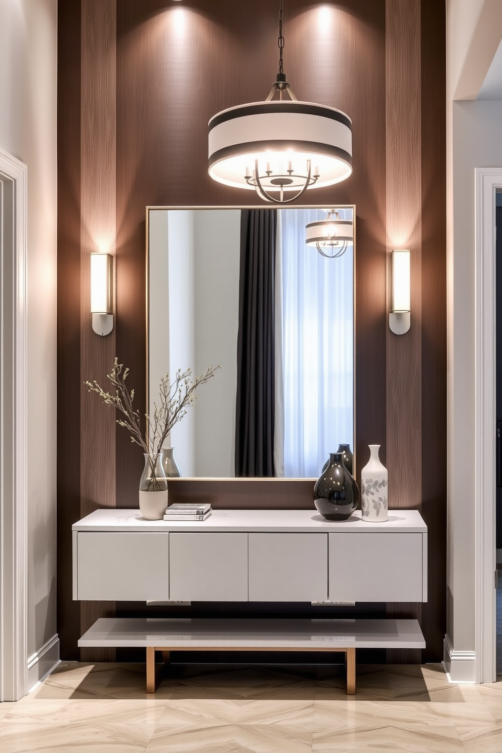 A modern entryway featuring layered lighting that enhances both ambiance and functionality. The space includes a sleek console table with decorative items, illuminated by a stylish pendant light overhead and wall sconces flanking a large mirror.