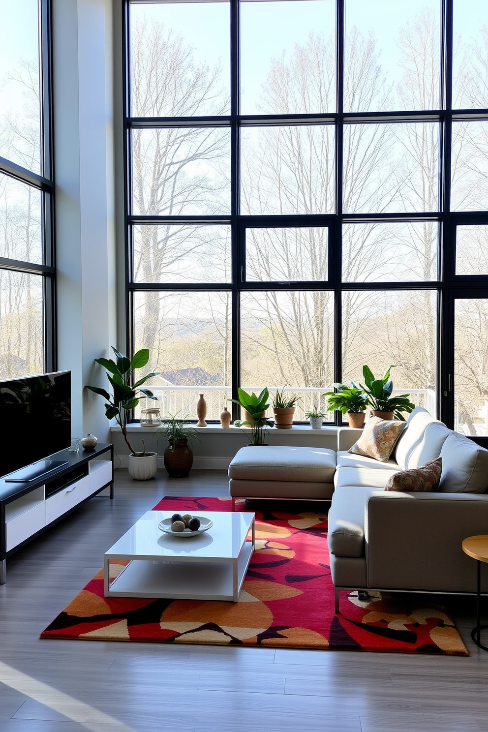 A modern family room with large windows that allow natural light to flood the space. The room features a comfortable sectional sofa in a neutral color, paired with a sleek coffee table and a vibrant area rug. On one side, a contemporary entertainment unit holds a flat-screen TV and decorative items. Potted plants are placed near the windows, adding a touch of greenery to the inviting atmosphere.