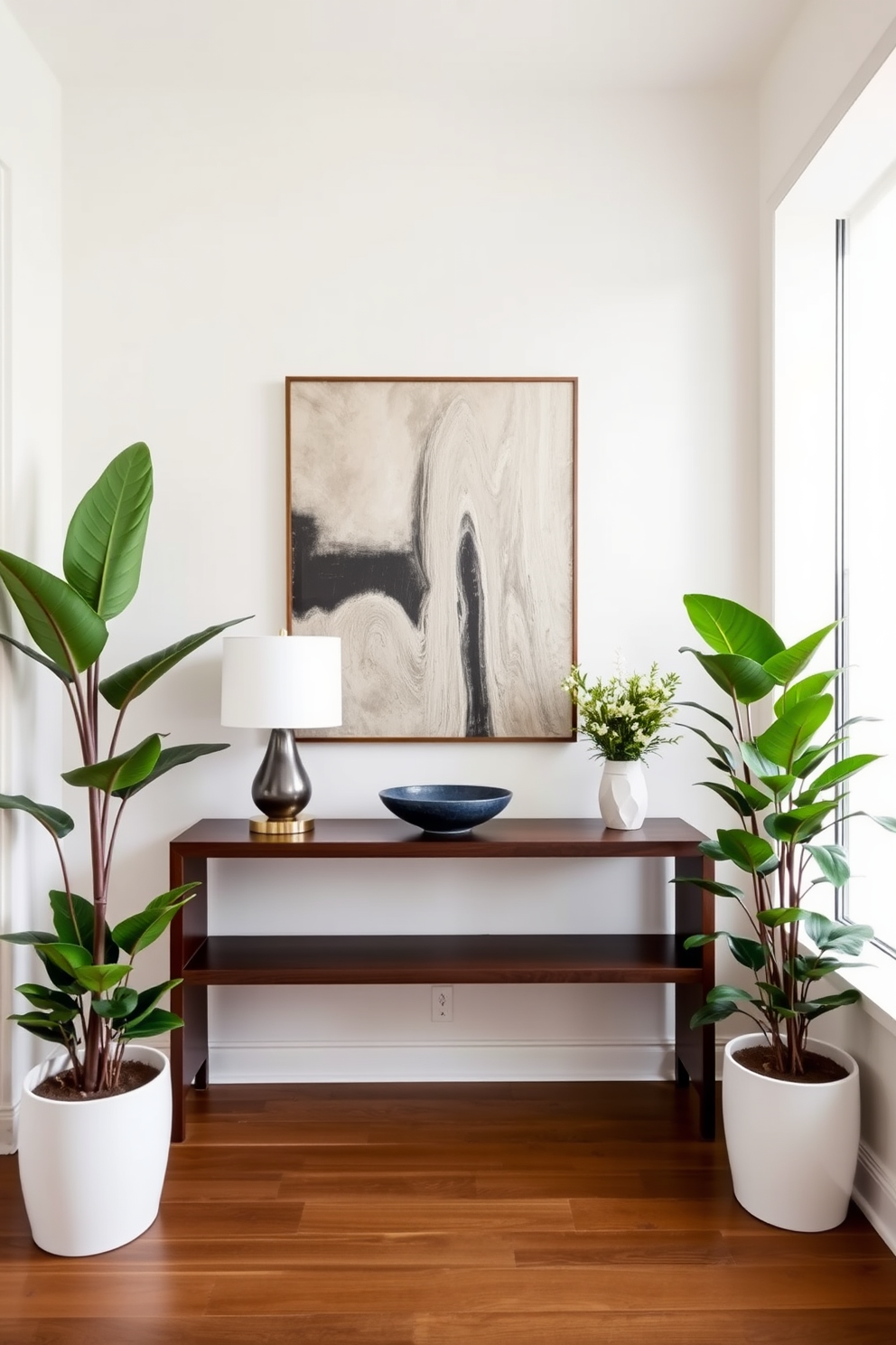 A modern foyer featuring a sleek console table made of dark wood, adorned with a stylish lamp and a decorative bowl. Lush indoor plants are strategically placed in the corners, adding a vibrant touch and creating a fresh atmosphere. The walls are painted in a soft neutral tone, complemented by a statement piece of artwork above the console. A large mirror hangs opposite the entrance, reflecting natural light and enhancing the sense of space.